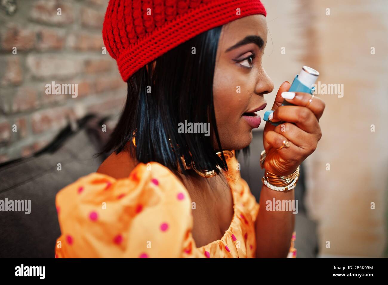 Young african american woman using asthma inhaler. Suffering sickness ...