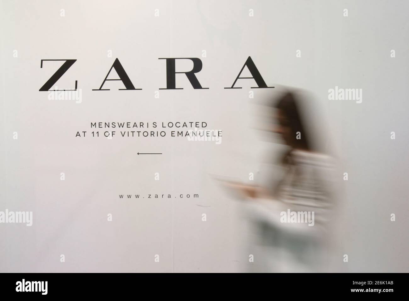 A woman walks in front of an advertisement for an Inditex owned Zara store  in Milan, Italy, March 30, 2017. REUTERS/Alessandro Garofalo Stock Photo -  Alamy