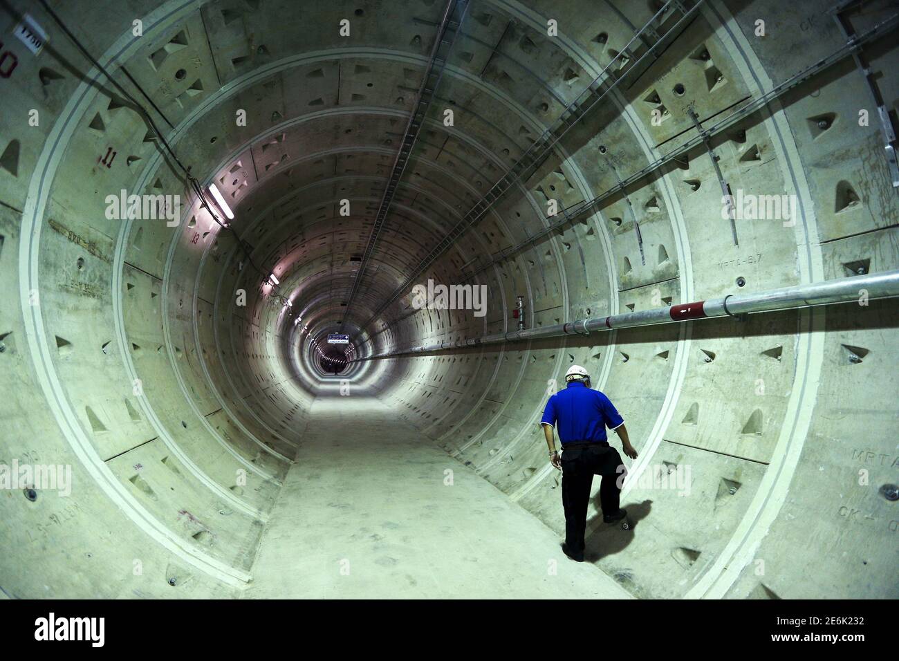 A construction worker walks inside a tunnel under the Chao Phraya river at a Mass Rapid Transit subway station in Bangkok, Thailand, December 14, 2015. REUTERS/Athit Perawongmetha Stock Photo