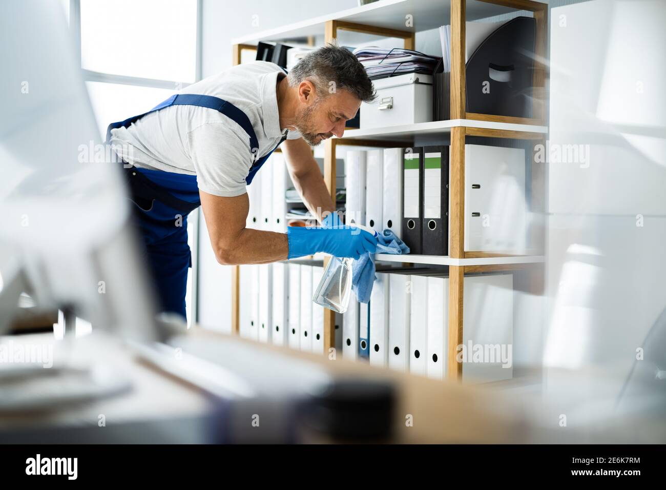 Professional Janitor Office Cleaning Service. Man With Chemical Spray