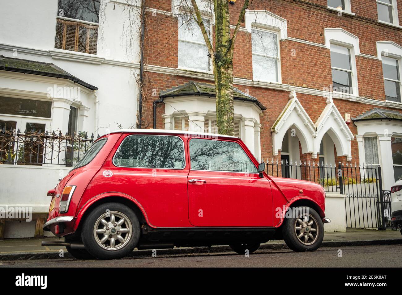 An old red Mini Cooper on London street Stock Photo