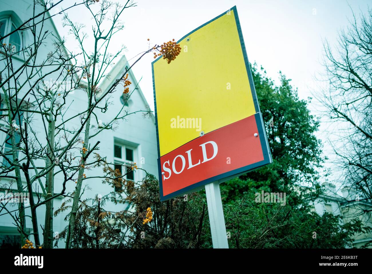 Estate Agent  'Sold' sign on urban UK street Stock Photo