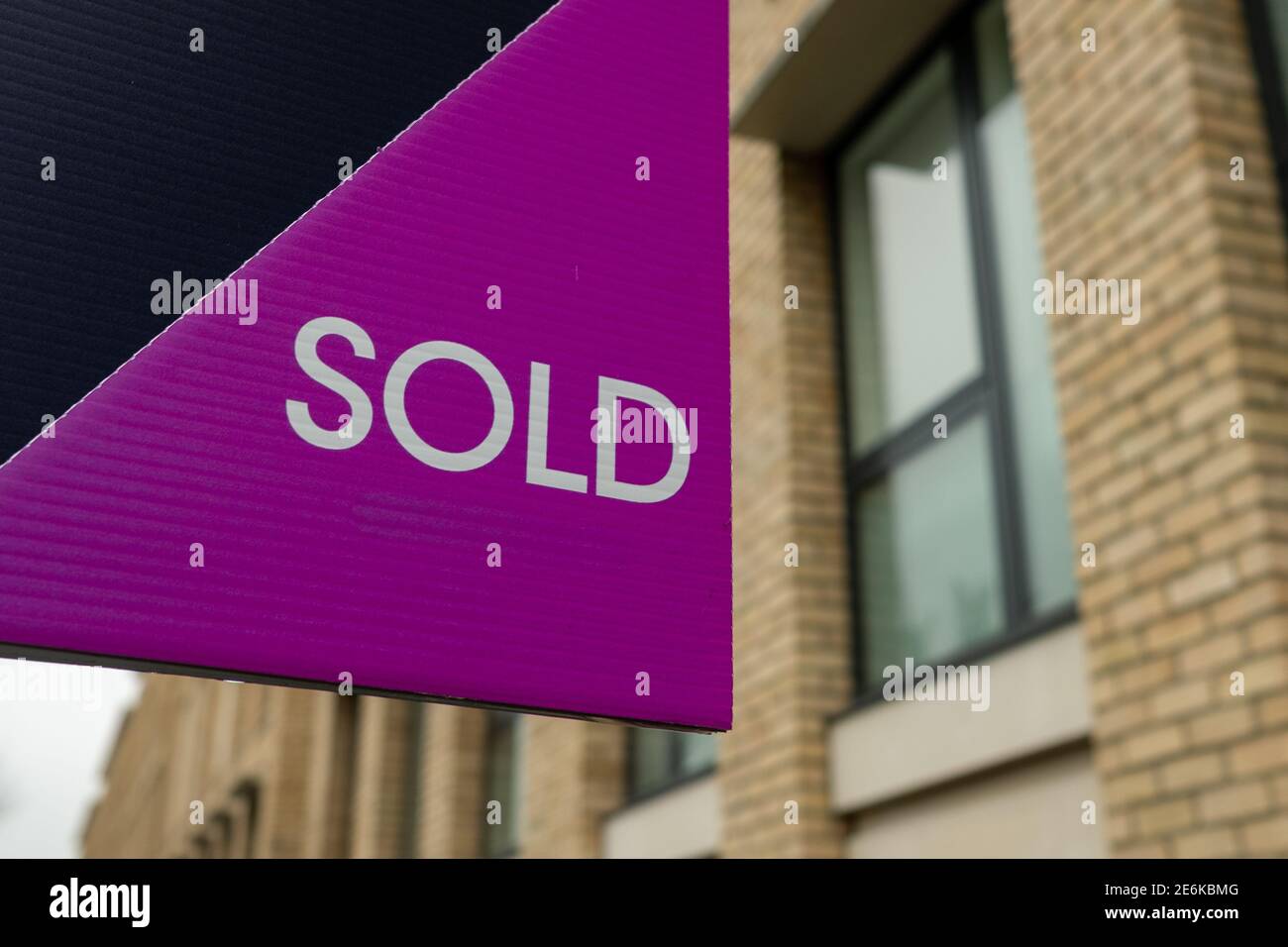 Estate Agent  'Sold' sign on urban UK street Stock Photo