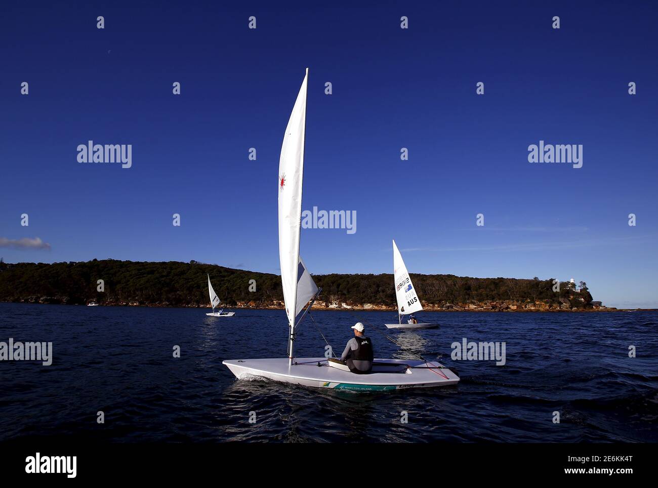 Australian Olympic team sailor Tom Burton (C) sails his laser yacht during  a training session next to Finn Alexander (L) and Stuart Plenderleith, both  contenders to represent Australia at the World Youth