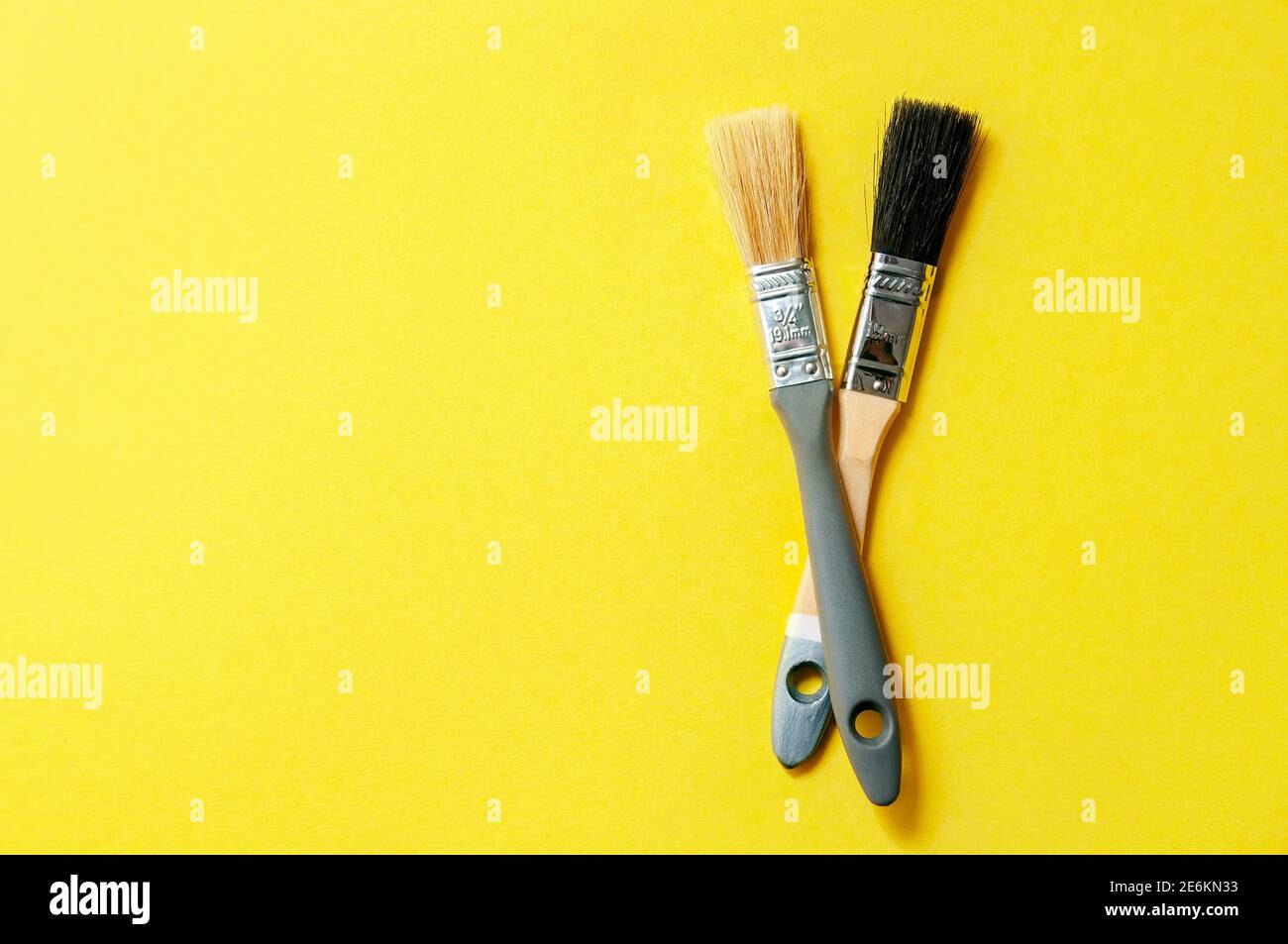 Color of the Year 2021. Gray Brushes on Yellow Background. Concept Repair. Stock Photo