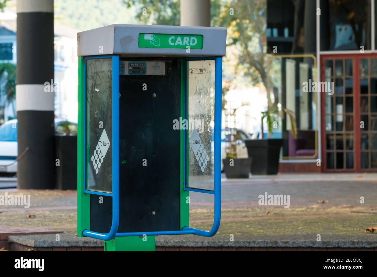 Telkom phone box or booth which has been vandalised and is empty in Cape Town, South Africa Stock Photo