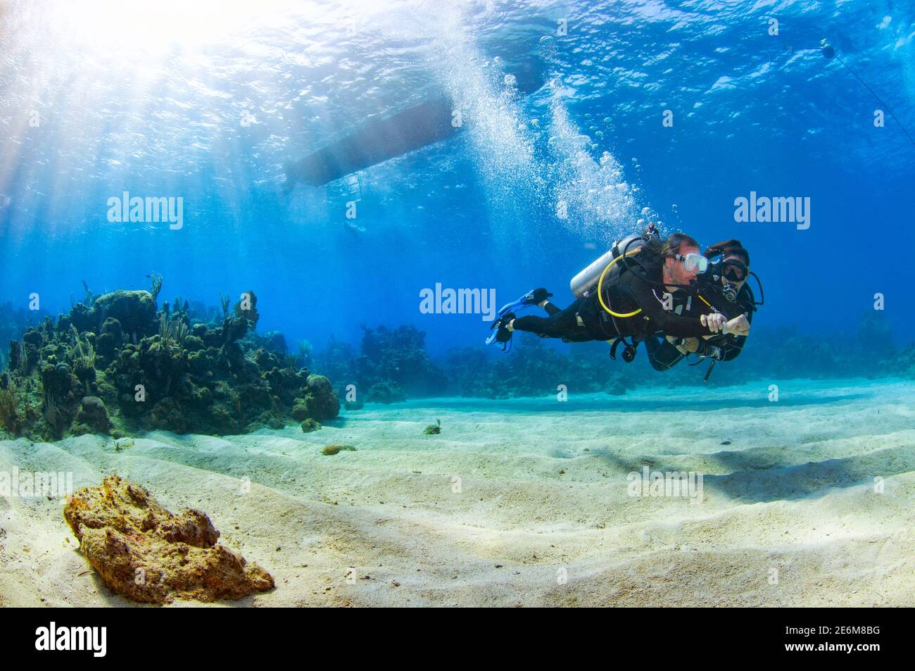 Scuba diver instructor with student during a scuba compass navigation