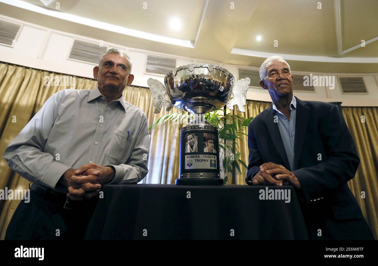 Former West Indies cricketer Garfield Sobers (R) and former Sri Lankan cricketer Michael Tissera pose for a photograph with the Sober-Tissera trophy, which is for the ongoing Sri Lanka and West Indies test cricket series, in Colombo October 21, 2015. Sobers and Tissera are in Sri Lanka to witness the upcoming second test match between Sri Lanka and the visiting West Indies. REUTERS/Dinuka Liyanawatte Stock Photo