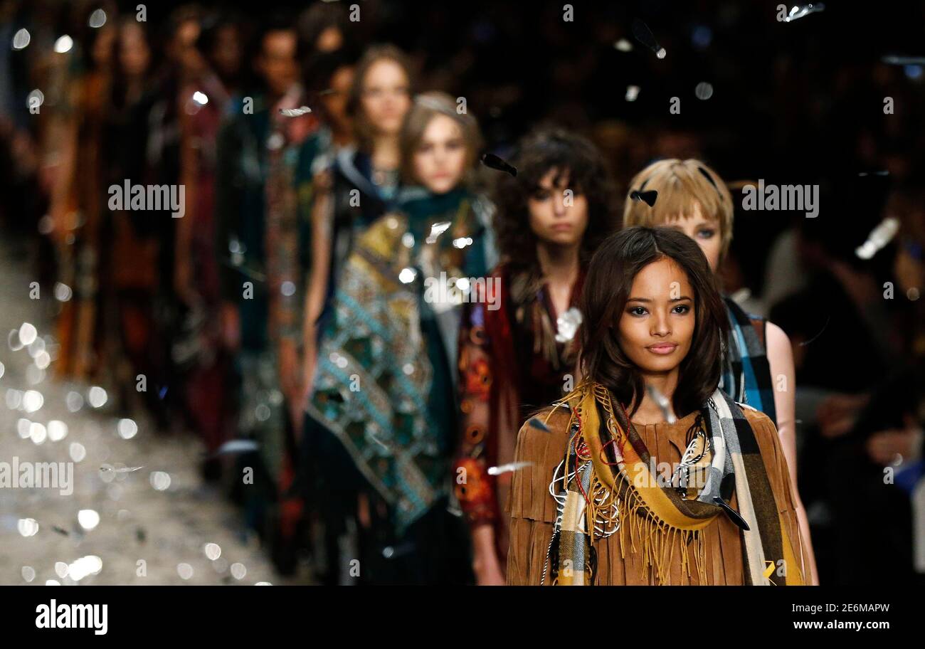 Models present creations from the Burberry Prorsum Autumn/Winter 2015 collection during London Fashion Week in this February 23, 2015 file photo. British luxury fashion brand Burberry said on February 5, 2016 it would merge its four annual catwalk shows into two and make its runway collections available to shoppers immediately. REUTERS/Suzanne Plunkett/Files Stock Photo