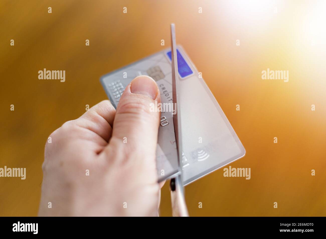 Irreversible destruction of a deactivated payment card by cutting with scissors Stock Photo