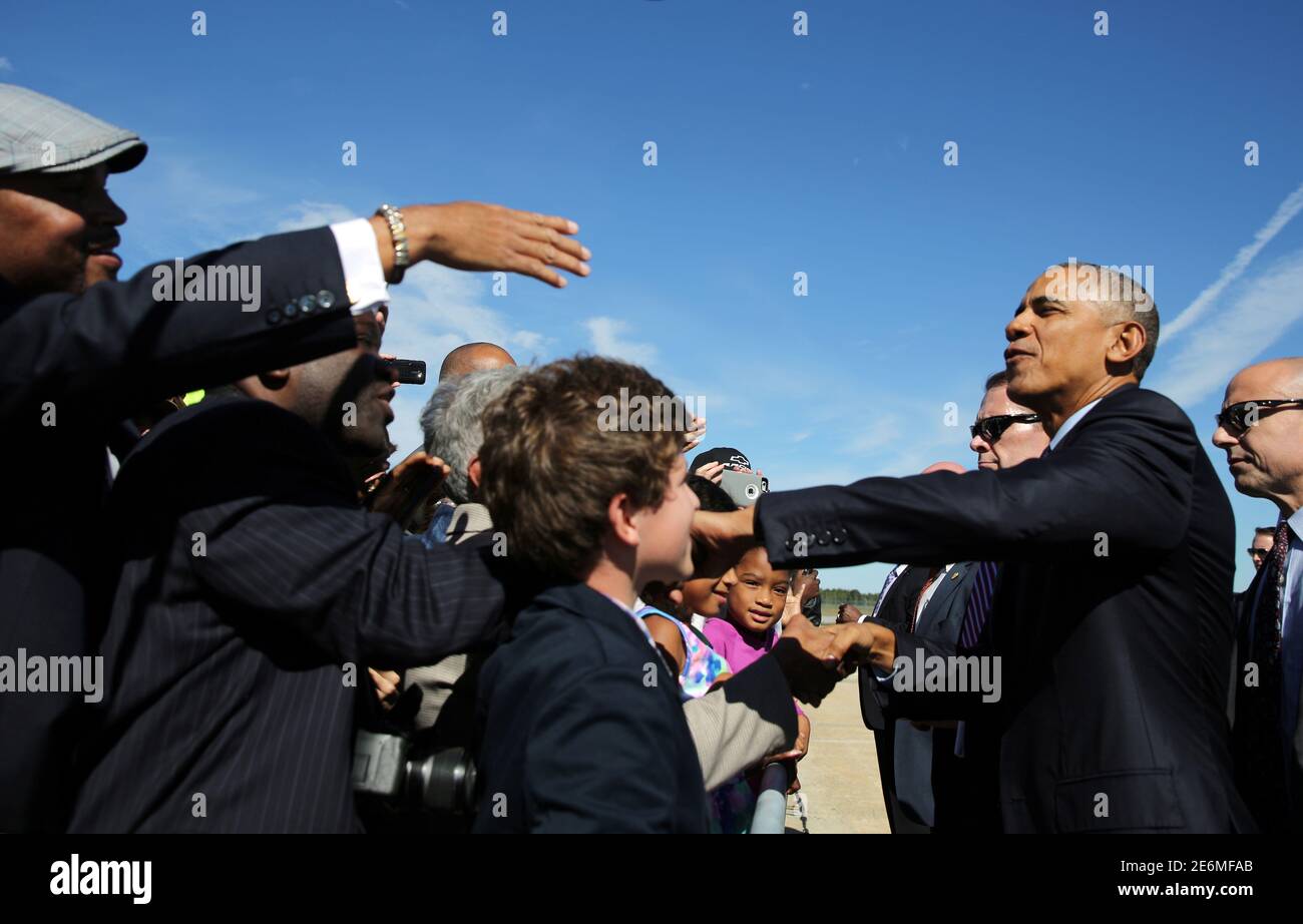 U.S. President Barack Obama greets local residents as he arrives at Piedmont Triad International Airport in Greensboro, North Carolina, U.S. October 11, 2016.  REUTERS/Carlos Barria Stock Photo