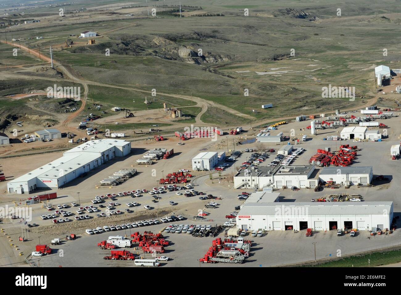 Idle trucks and oil production equipment is seen in a Halliburton yard in Williston, North Dakota April 30, 2016. Picture taken April 30, 2016. REUTERS/Andrew Cullen Stock Photo