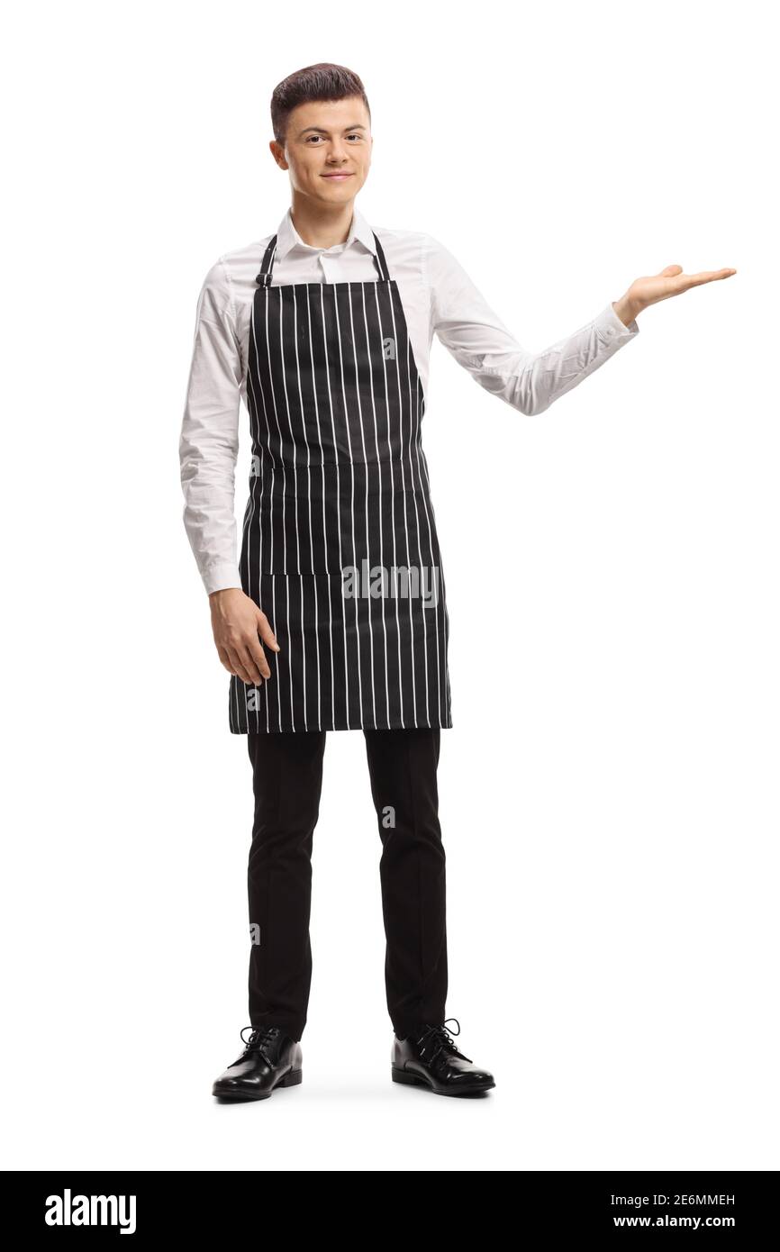 Young male waiter with an apron welcoming with hand isolated on white background Stock Photo
