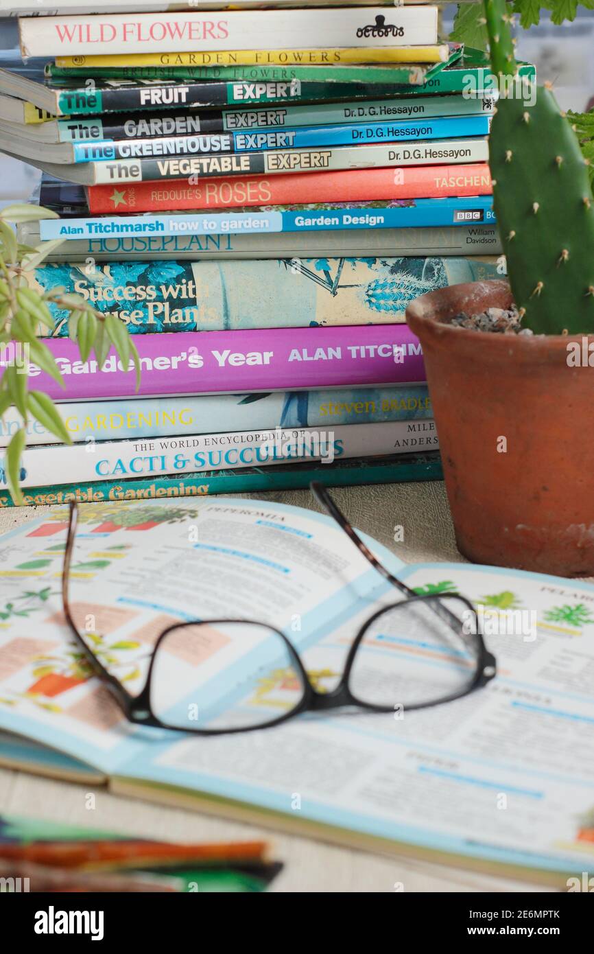 Gardening books and reading glasses in an English home. UK Stock Photo