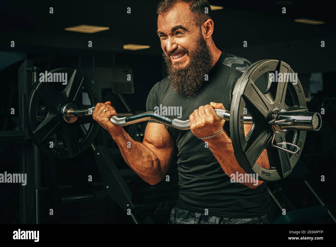 Powerlifter with strong arms lifting barbell in a gym Stock Photo Alamy