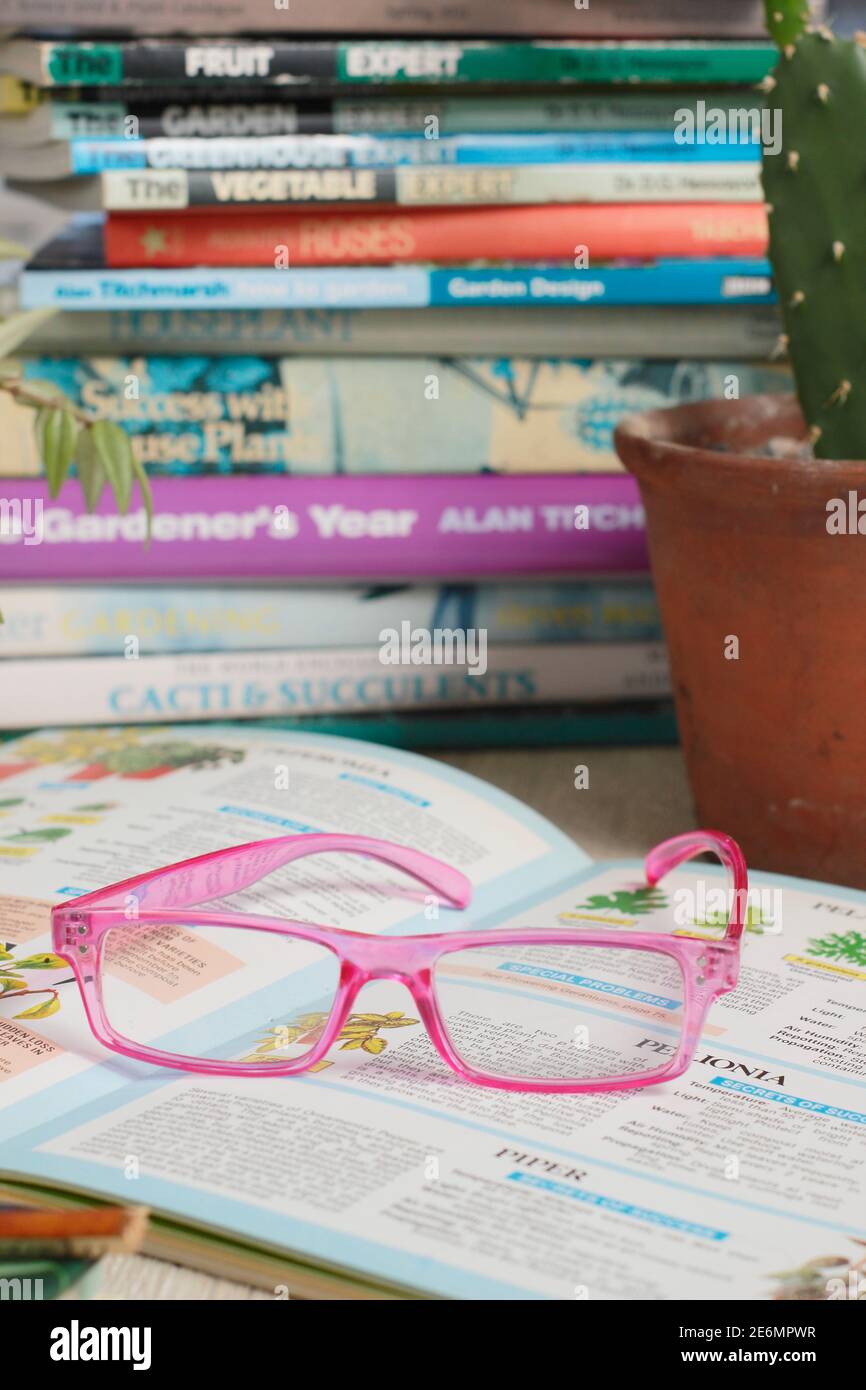 Gardening books and reading glasses in an English home. UK Stock Photo