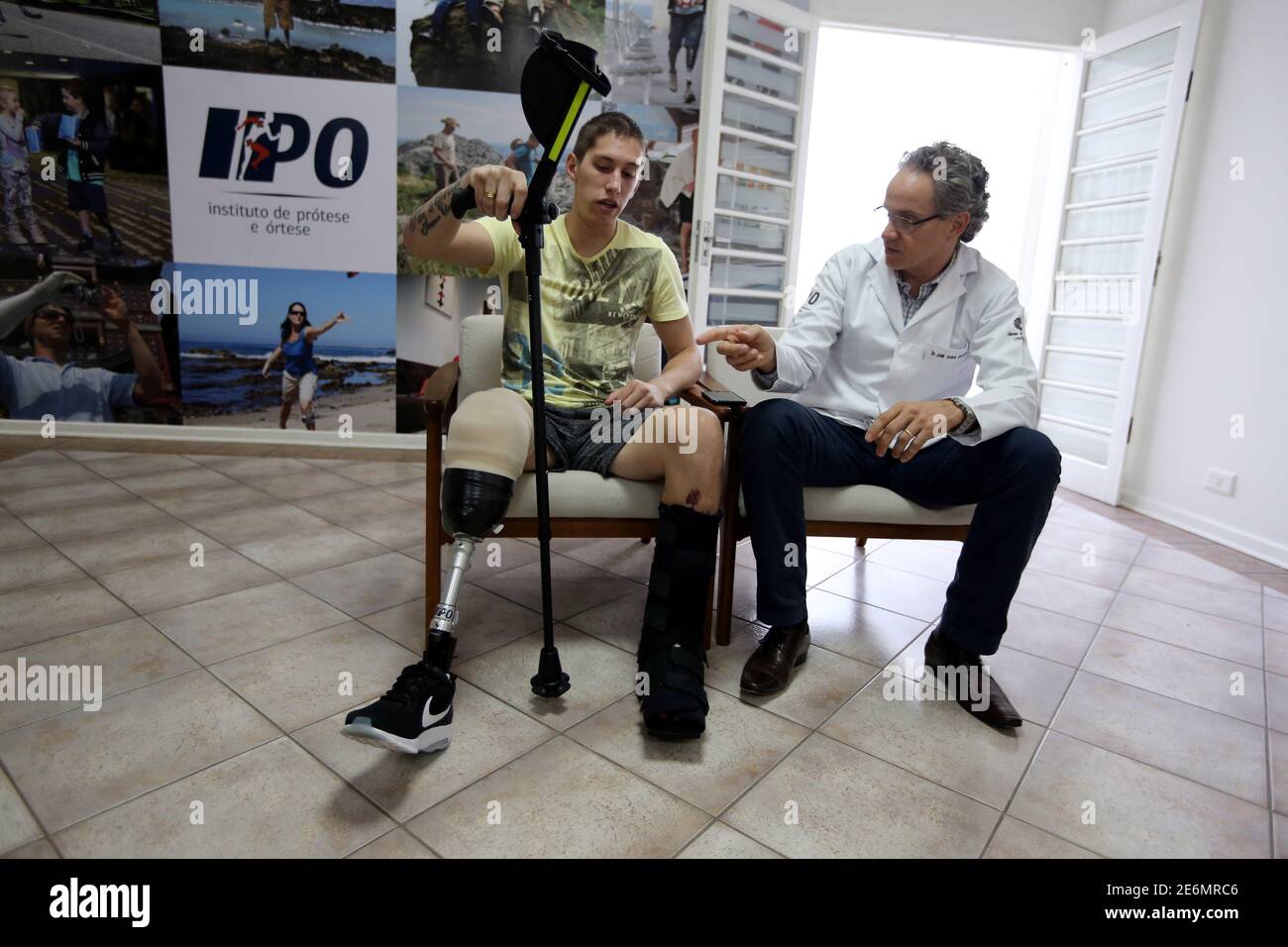 Goalkeeper Jackson Follmann, who survived when the plane carrying Brazilian soccer team Chapecoense crashed, talks with Dr. Jose Carvalho as they try on a prosthetic leg in Sao Paulo, Brazil, February 21, 2017. REUTERS/Paulo Whitaker Stock Photo