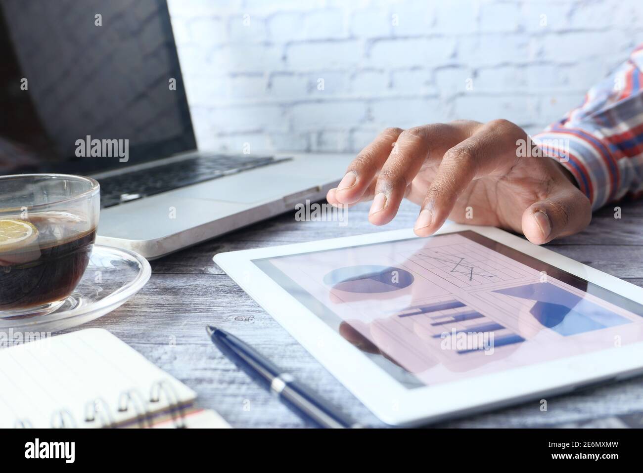 man's hand working on digital tablet at office desk, using self created ...