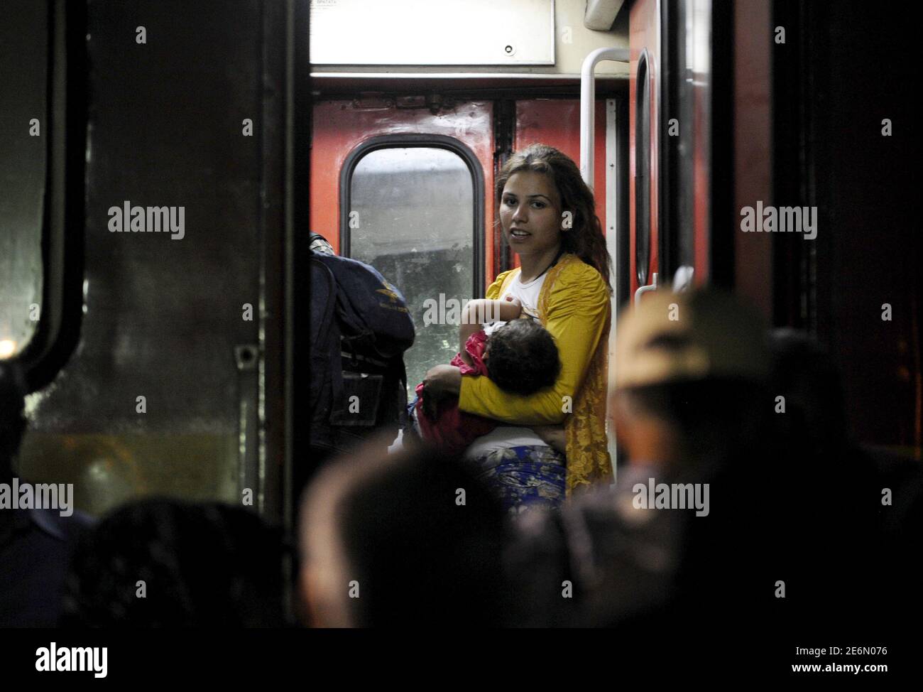 Migrant breastfeeds her baby on board a northbound train, at Macedonia's south border near Gevgelija August 26, 2015. The train will take them to Macedonia's north border with Serbia, on their way to Western Europe.   REUTERS/Ognen Teofilovski Stock Photo
