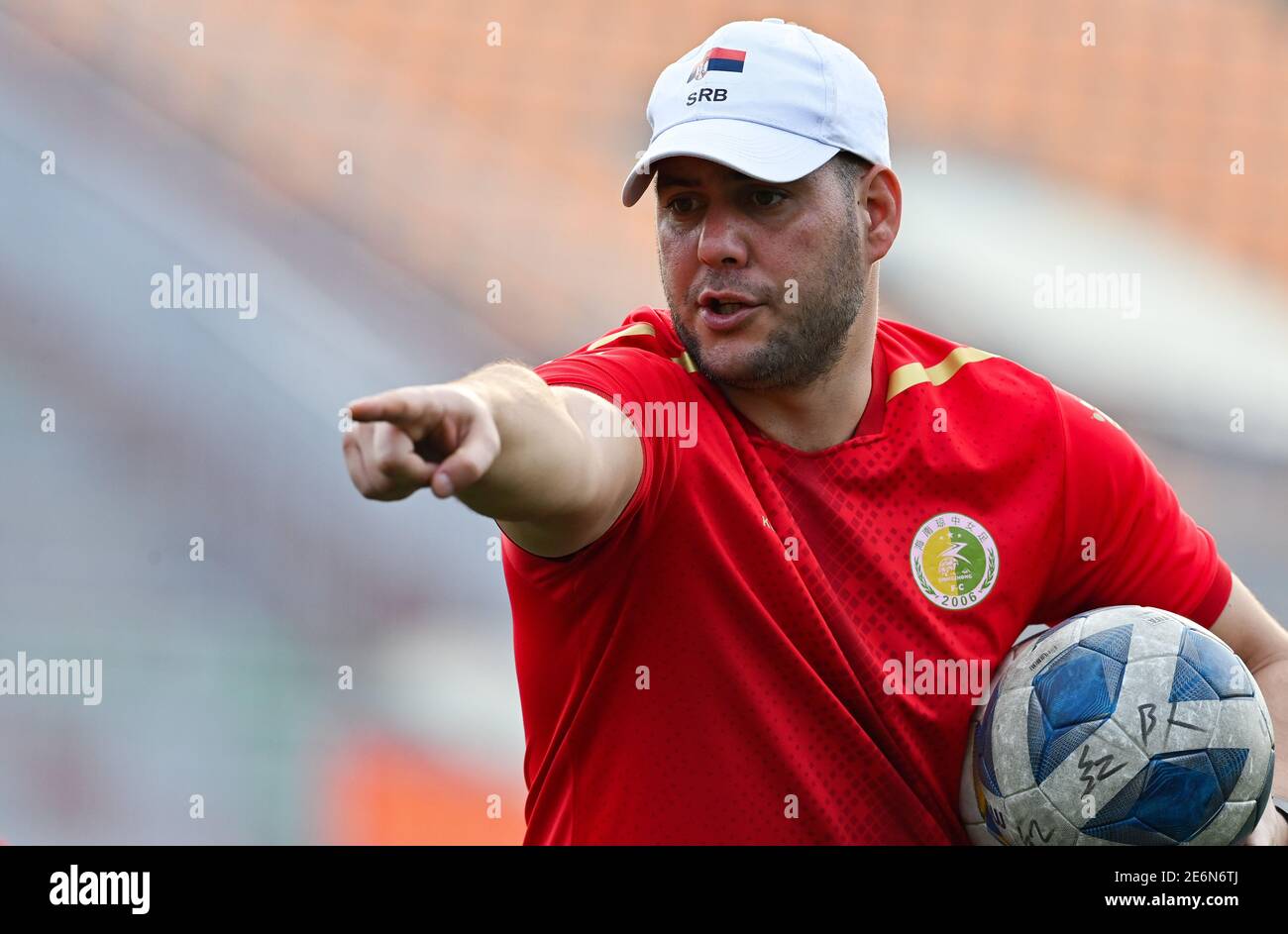 (210129) -- QIONGZHONG, Jan. 29, 2021 (Xinhua) -- Igor Baletic, goalkeeper coach of Qiongzhong Women's Football team, gestures while instructing players during a trainning session at the Qiongzhong Women's Football Training Base in Qiongzhong, south China's Hainan Province, Jan. 26, 2021. Having ever acted as the goalkeeper coach of Serbia's U17 national team, 35-year-old Igor Baletic came to Qiongzhong in 2019 and took over as the goalkeeper coach of Qiongzhong Women's Football team.During the training, Igor is quite strict with players, providing frequent guidance and demonstrations. When th Stock Photo