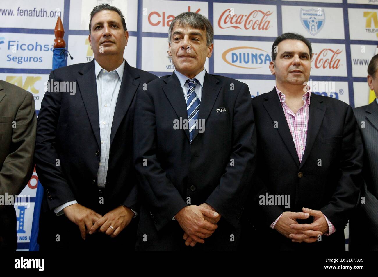 FIFA's representative Primo Corvado (C) poses for a picture with Jorge  Salomon (L) and Miguel Mourra, acting president and vice president of the  Honduran Football Association (FENAFUTH), during a news conference in