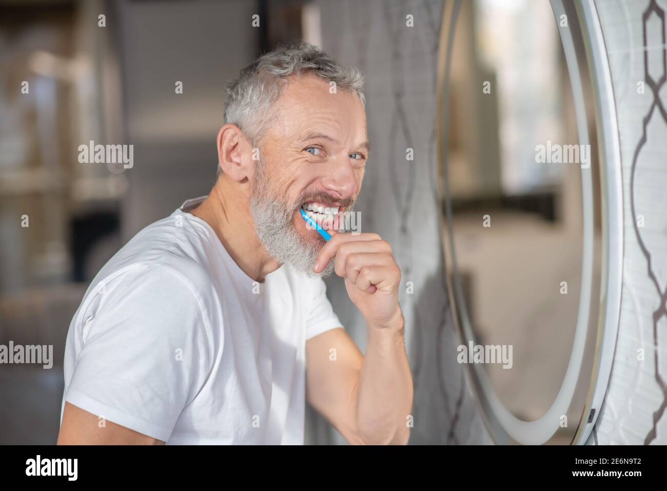 Man brushing his teeth with a new toothpaste Stock Photo - Alamy