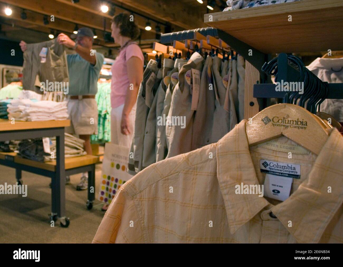 Customers shop at the Columbia Sportswear flagship store in Portland, Oregon,  July 27, 2006. Columbia Sportswear Co. on Thursday reported a 24 percent  decline in quarterly net income due to costs for