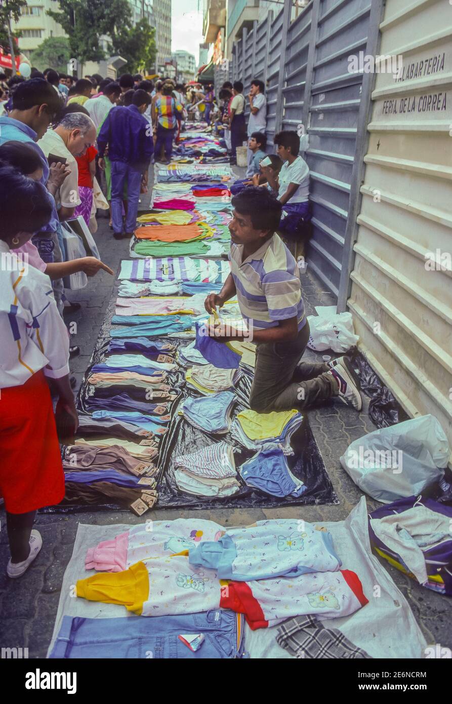 CARACAS, VENEZUELA, 1988 - Street vendors selling clothing on sidewalk in downtown Caracas. Stock Photo