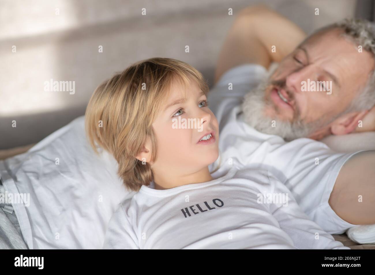 Smiling baby talking and considerate dad Stock Photo