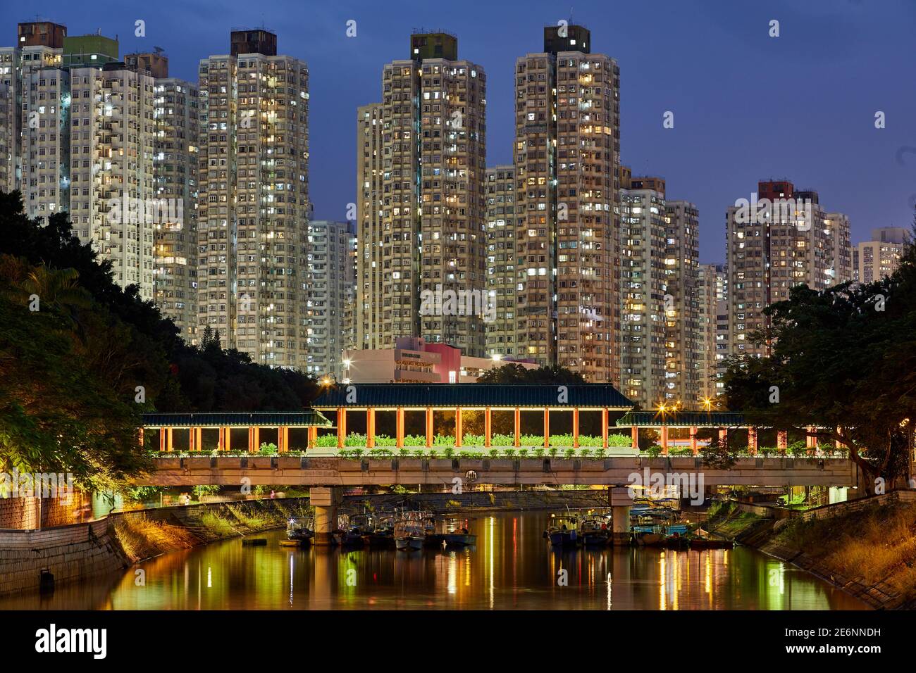 Bridge across the Lam Tsuen River in Tai Po with high rise residential apartment blocks. New Territories, Hong Kong Stock Photo