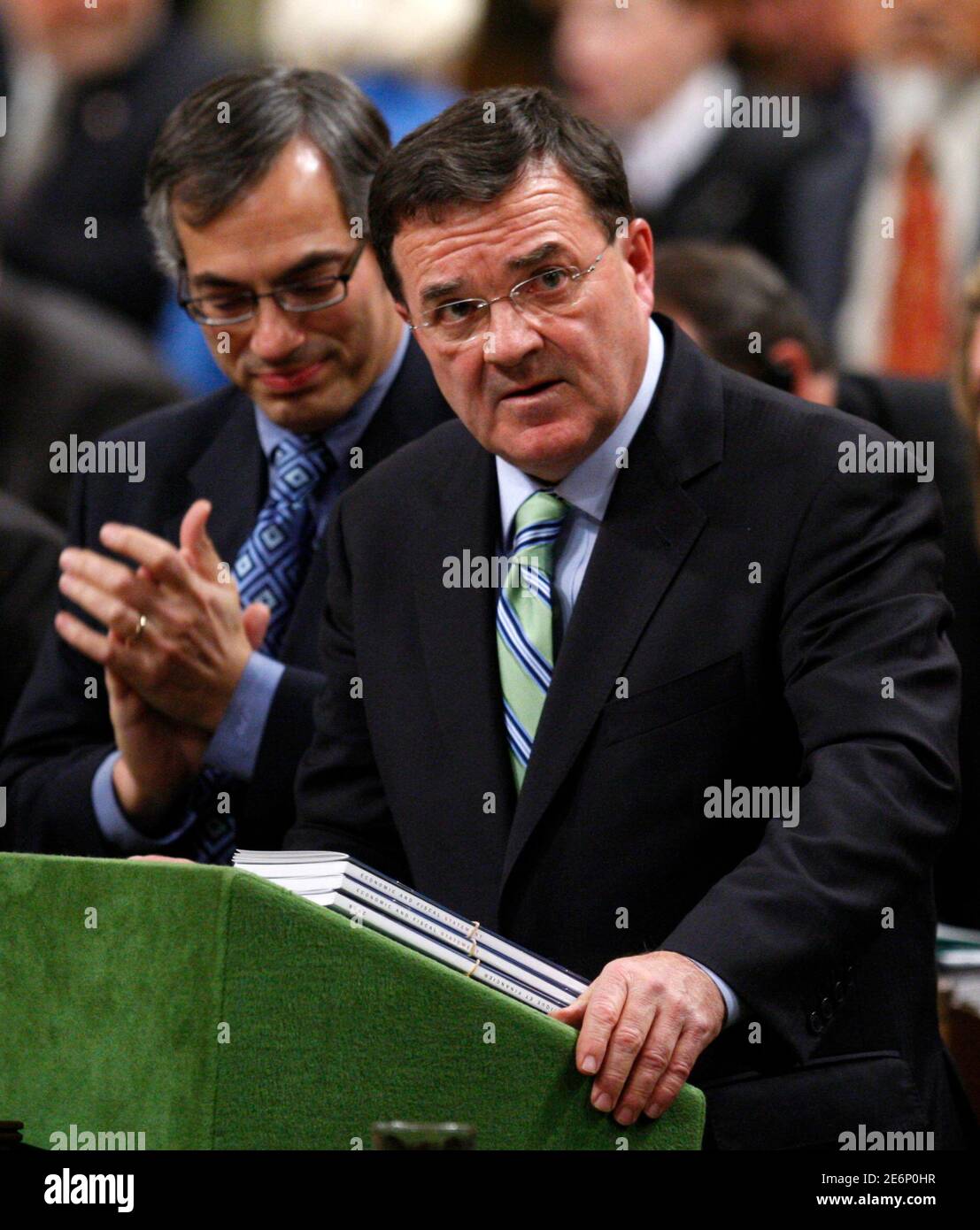 Canada's Finance Minister Jim Flaherty receives a standing ovation from his caucus while delivering the government's fiscal update in the House of Commons on Parliament Hill in Ottawa November 27, 2008. The Canadian economy has slipped into recession and the federal coffers are on the verge of running dry for the first time in 13 years, the government said on Thursday in a report that raised the prospect of an early election.    REUTERS/Chris Wattie (CANADA) Stock Photo