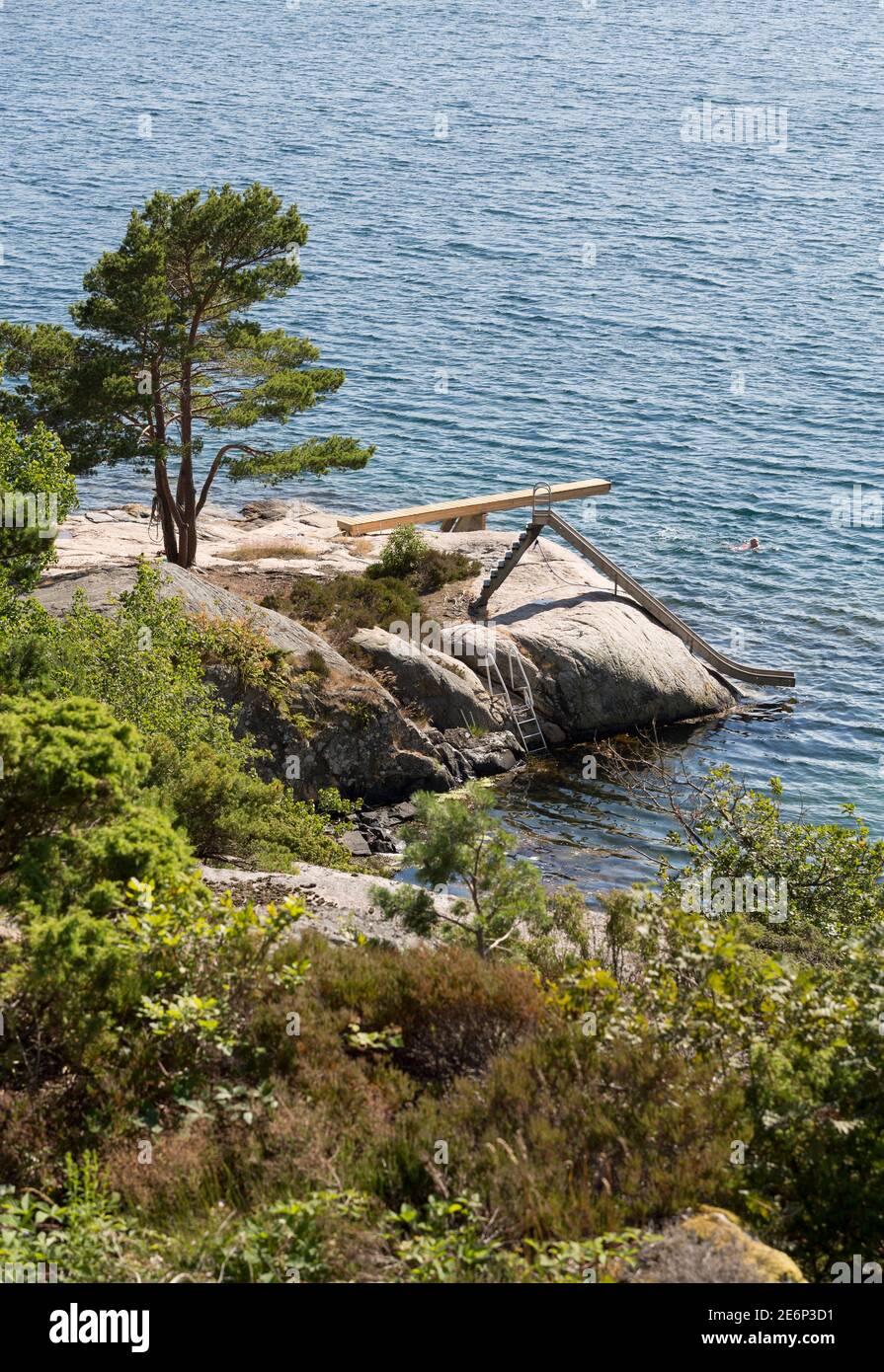 Diving board, a slide and a ladder on a low cliff at the southern coast