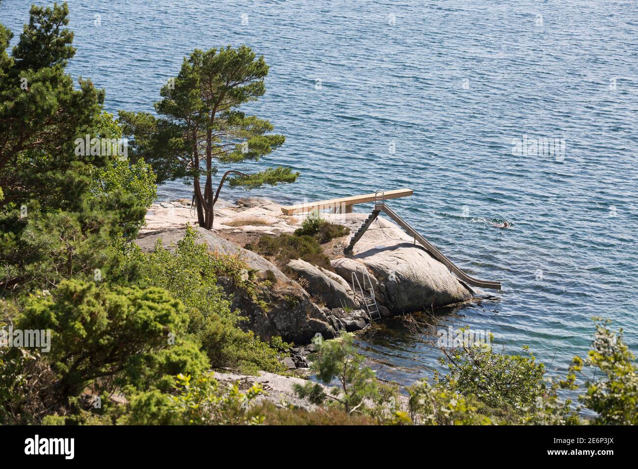 Diving board, a slide and a ladder on a low cliff at the southern coast