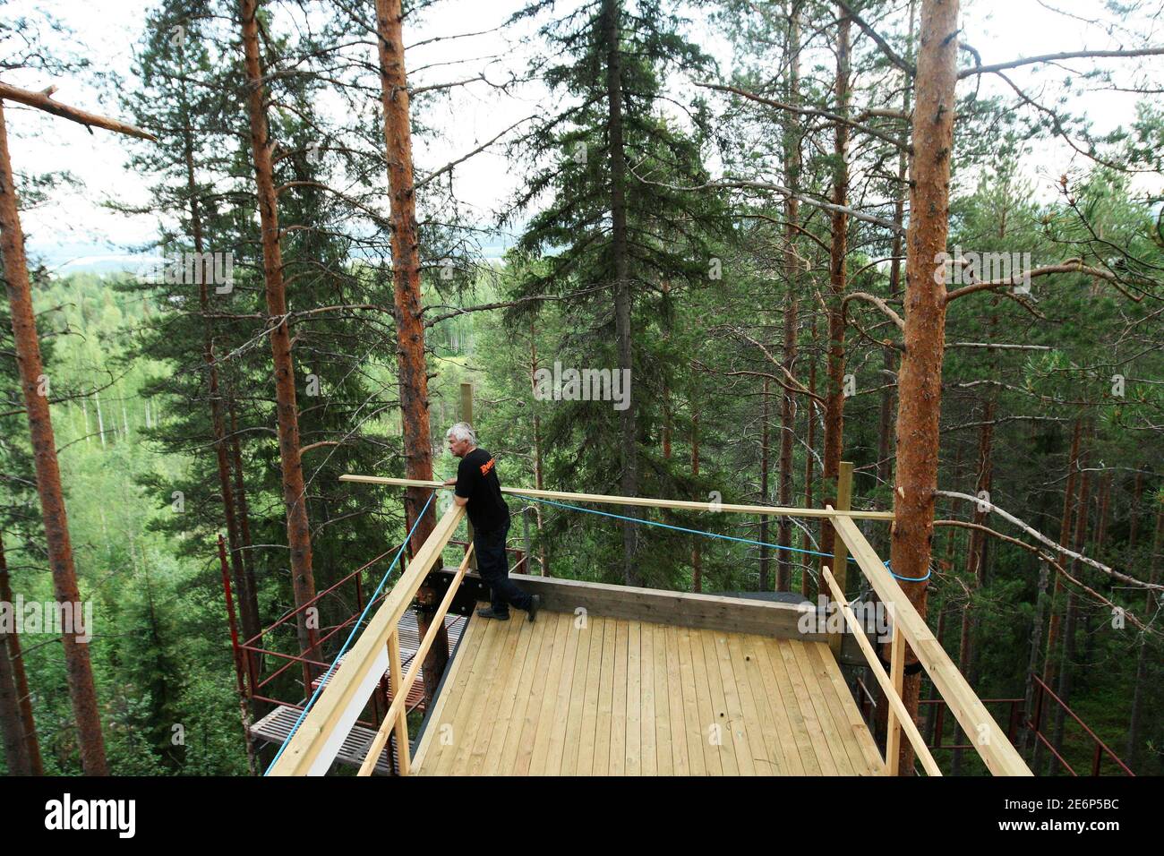Treehotel co-founder Kent Lindvall poses for a picture on the rooftop balcony of The Cabin on the construction site of Treehotel in the Swedish village of Harads, July 5, 2010. A lofty new hotel concept is set to open in a remote village in northern Sweden, which aims to elevate the simple treehouse into a world-class destination for design-conscious travellers. Treehotel, located in Harads about 60 km south of the Arctic Circle, will consist of four rooms when it opens on July 17th: The Cabin, The Blue Cone, The Nest and The Mirrorcube. Picture taken July 5, 2010.     To match Reuters Life! S Stock Photo