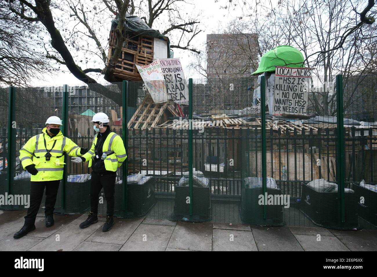 Security by the encampment in Euston Square Gardens in central London, where protesters have built a 100ft tunnel network, which they are ready to occupy, after claiming the garden is at risk from the HS2 line development. Picture date: Friday January 29, 2021. Stock Photo