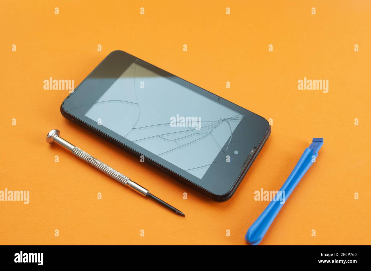 smart phone with broken screen and tools for repair. bright graphic image . Stock Photo