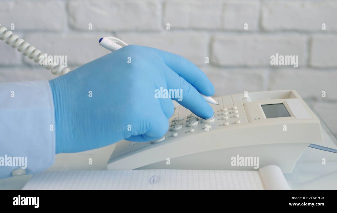 Image with a Doctor Making a Phone Call Using Hospital Landline Stock Photo