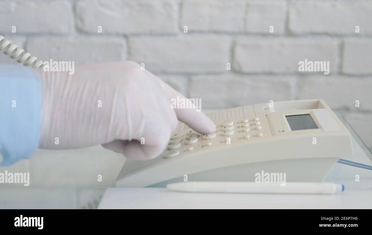 Image with a Doctor Making a Phone Call Using Hospital Landline Stock Photo