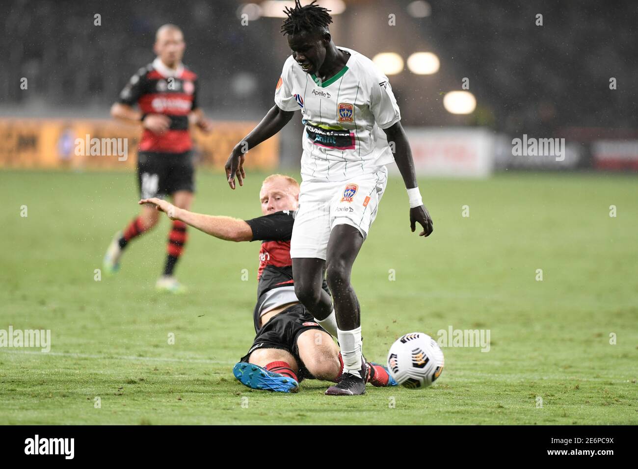 Parramatta, New South Wales, Australia. 29th January 2021:  A League Football, Western Sydney Wanderers versus Newcastle Jets; Valentino Yuel of Newcastle Jets is slide tackled by Ziggy Gordon of Western Sydney Wanderers Credit: Action Plus Sports Images/Alamy Live News Stock Photo