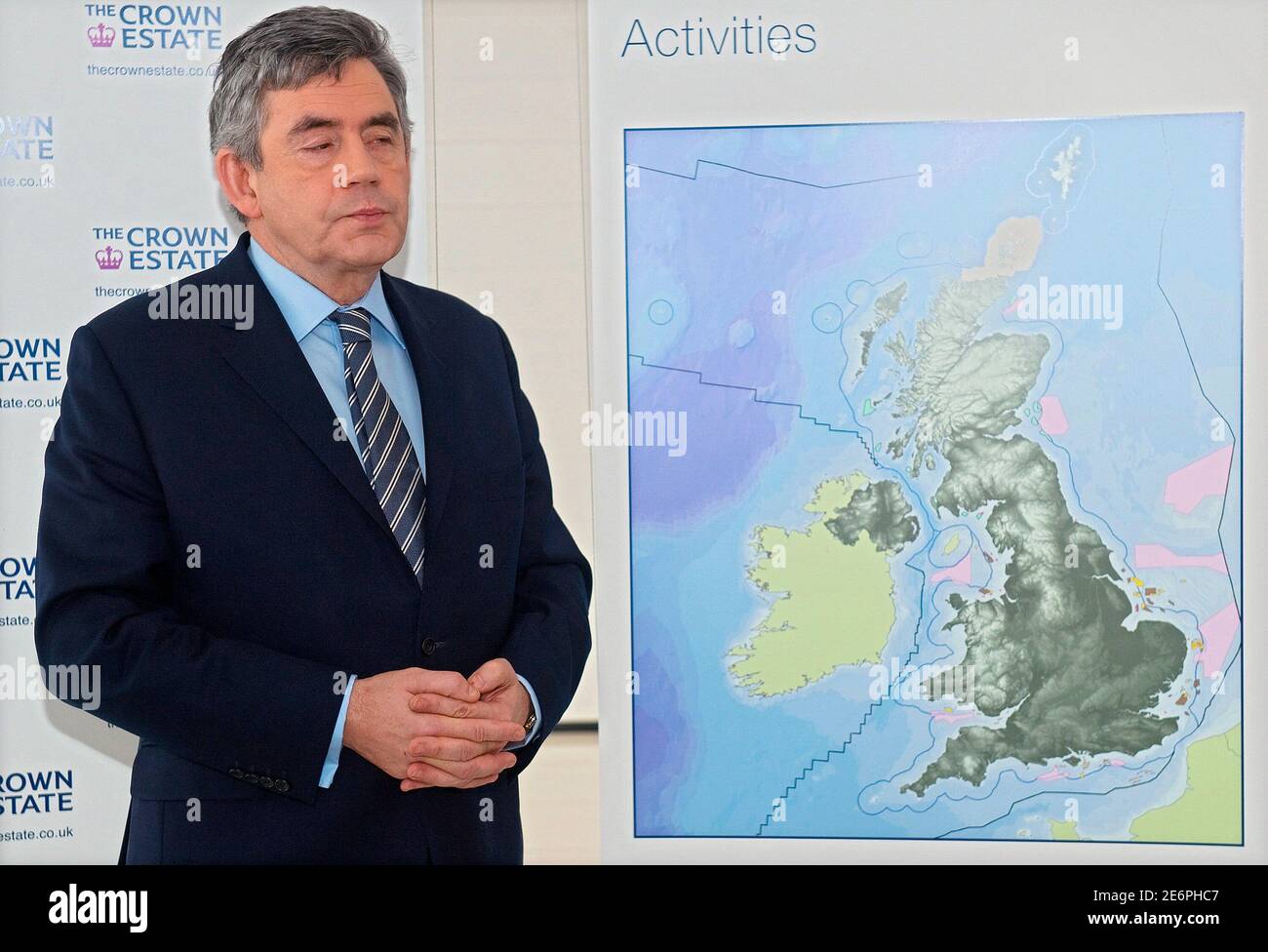 Britain's Prime Minister Gordon Brown stands with a map showing details of a new initiative to build off-shore wind farms, ahead of a news conference in central London January 8, 2010.  Britain has awarded energy companies rights to develop some of the world's biggest offshore wind farms, triggering a race to win financing for the complex, risky and high-maintenance projects. The Crown Estate, in charge of Britain's coastal seabed, on Friday announced winners for the Round 3 tender, including Portugal's EDP Renewables, Britain's Centrica, Germany's E.ON and Sweden's Vattenfall.     REUTERS/Leo Stock Photo