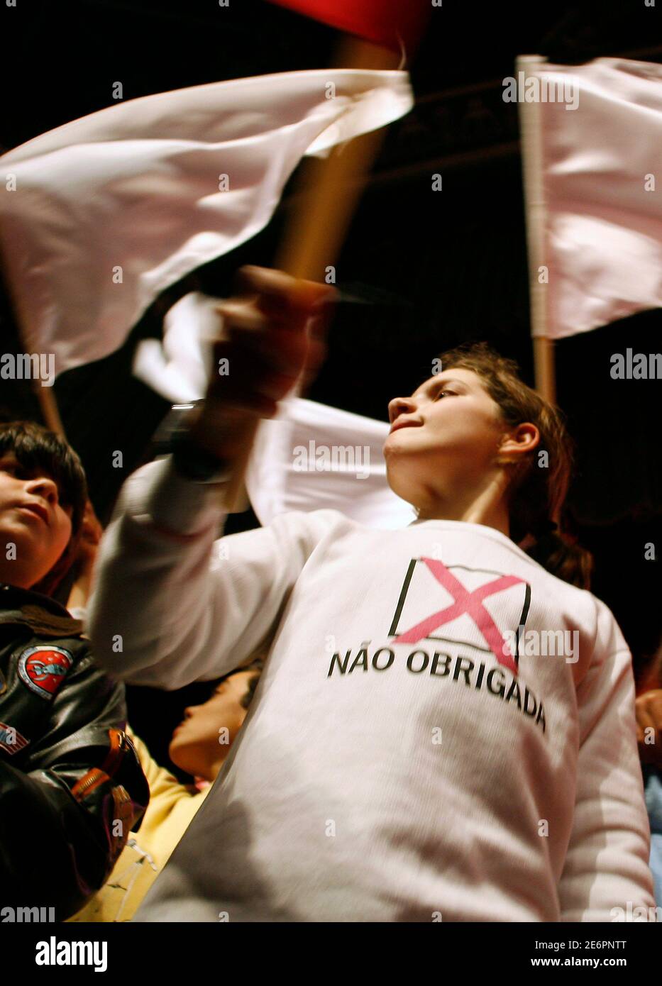 A girl wearing a t-shirt that reads 'No thanks' waves a flag during an anti-abortion rally in Lisbon February 8, 2007. The Portuguese vote on Sunday in a referendum on legalising abortion which pits liberals seeking a more open society against Roman Catholics determined to safeguard their traditional values. REUTERS/Jose Manuel Ribeiro (PORTUGAL) Stock Photo