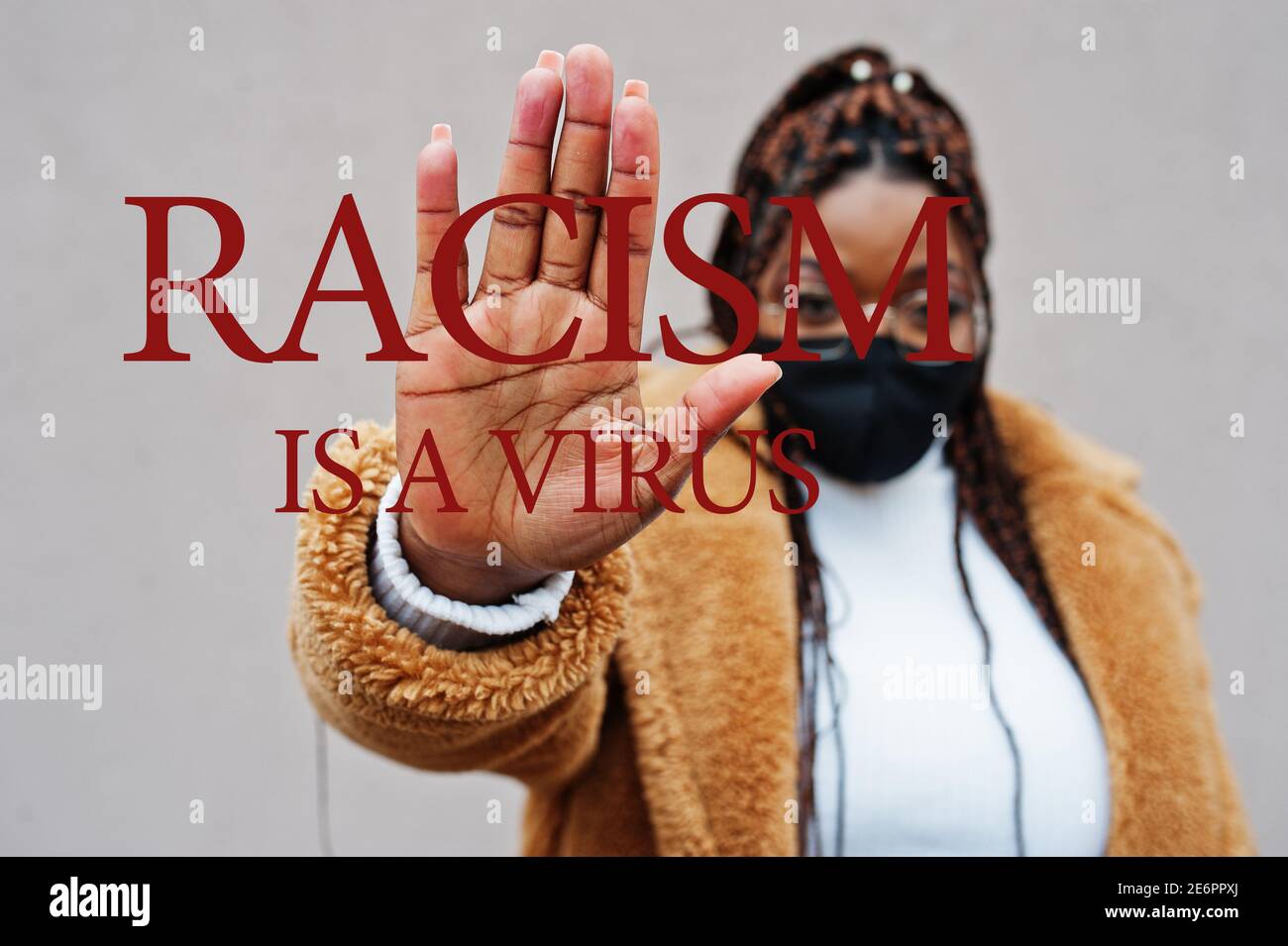 Anti Racism Mask Racism is a virus. African american woman, wear black face mask show ...