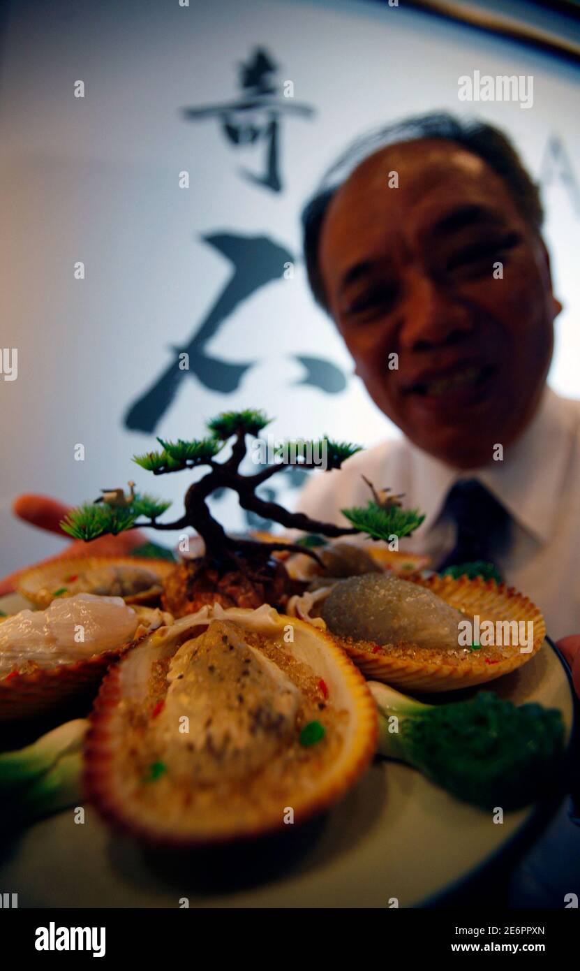 Rock Collector Hsu Chun I From Taiwan Poses As He Holds The Steamed Scallops Topped With Garlic Dish During A Preview Of The A Banquet In Stone Art Exhibition At The National Museum