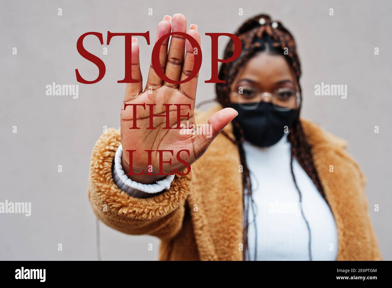 Stop the lies. African american woman, wear black face mask show stop hand sign. Stock Photo
