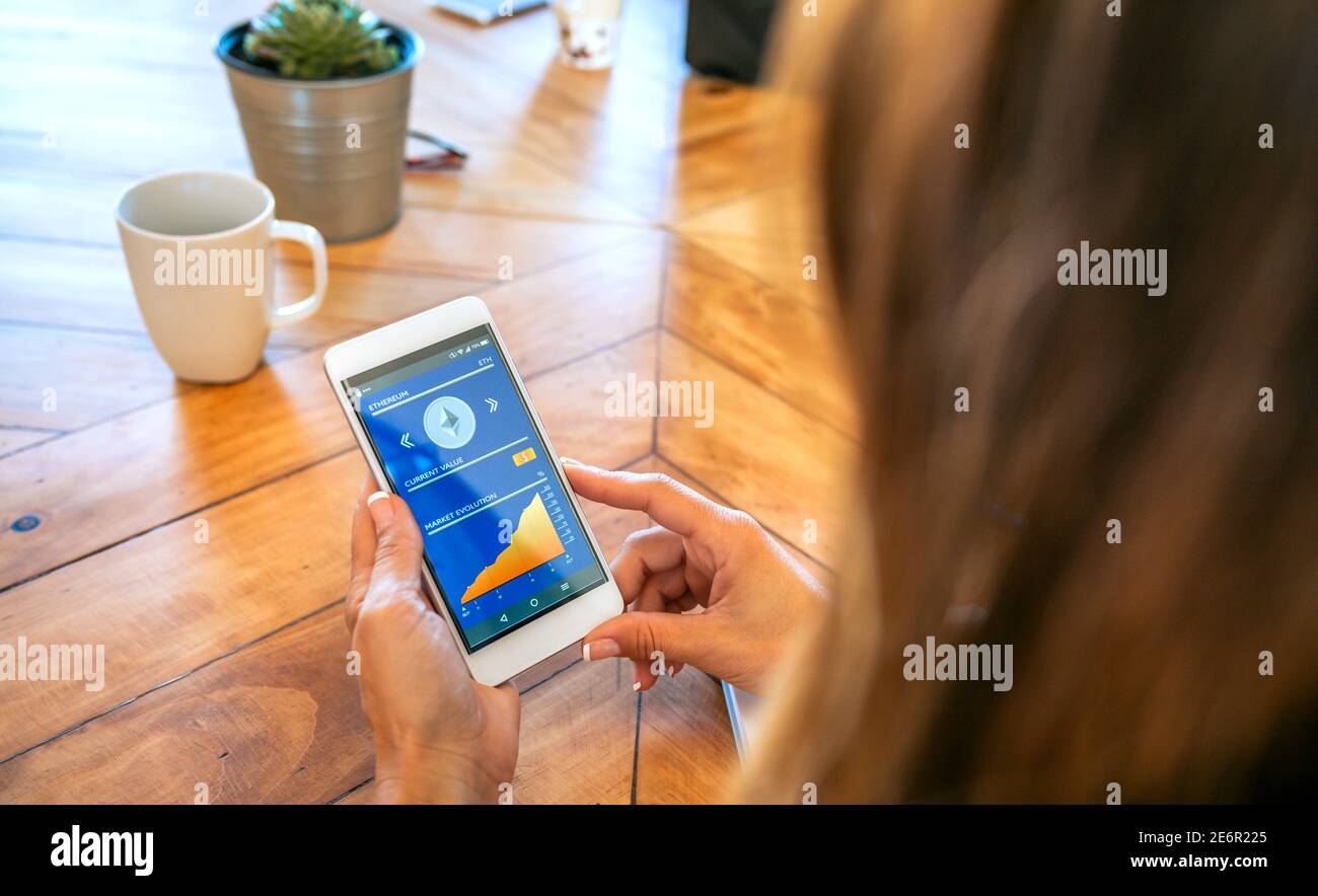 Businesswoman looking mobile with ethereum information Stock Photo