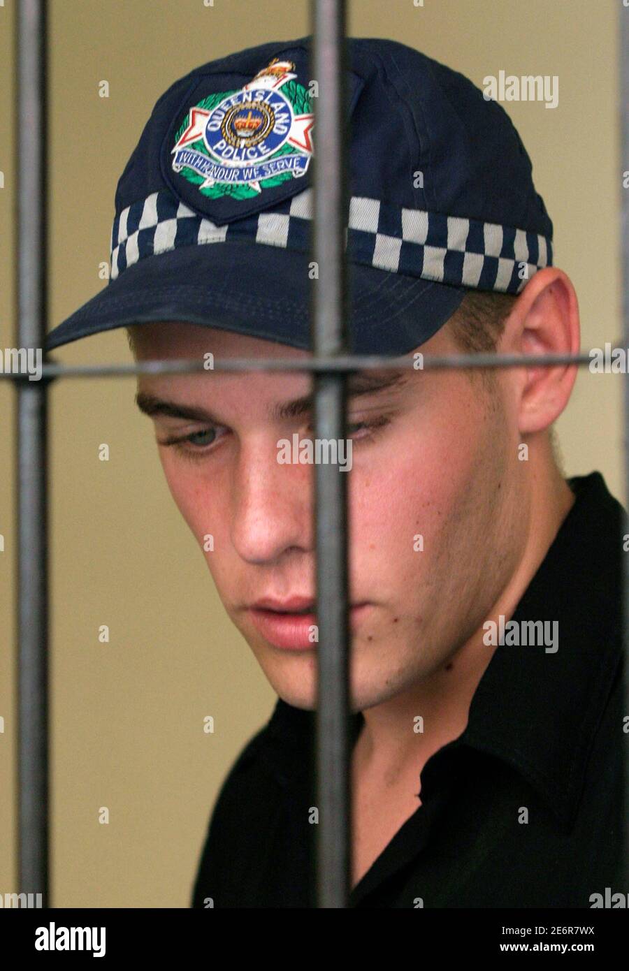 Australian Matthew Norman, part of the "Bali Nine" gang, wears a cap with  the words "Queensland Police" while he waits in a temporary cell for the  first day of a judicial review
