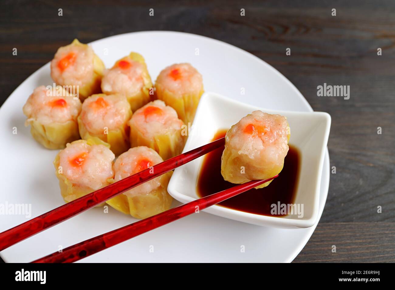 Shrimp and Pork Filled Chinese Steamed Dumpling Being Dipped in Soy