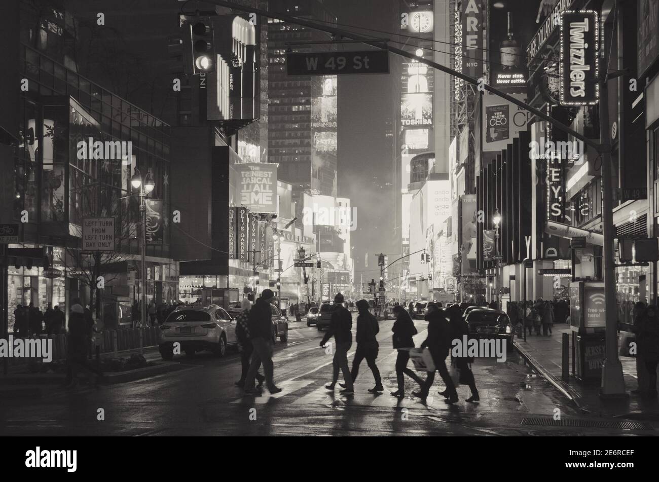 Silhouettes of People Crossing a Road in Times Square. Black and White