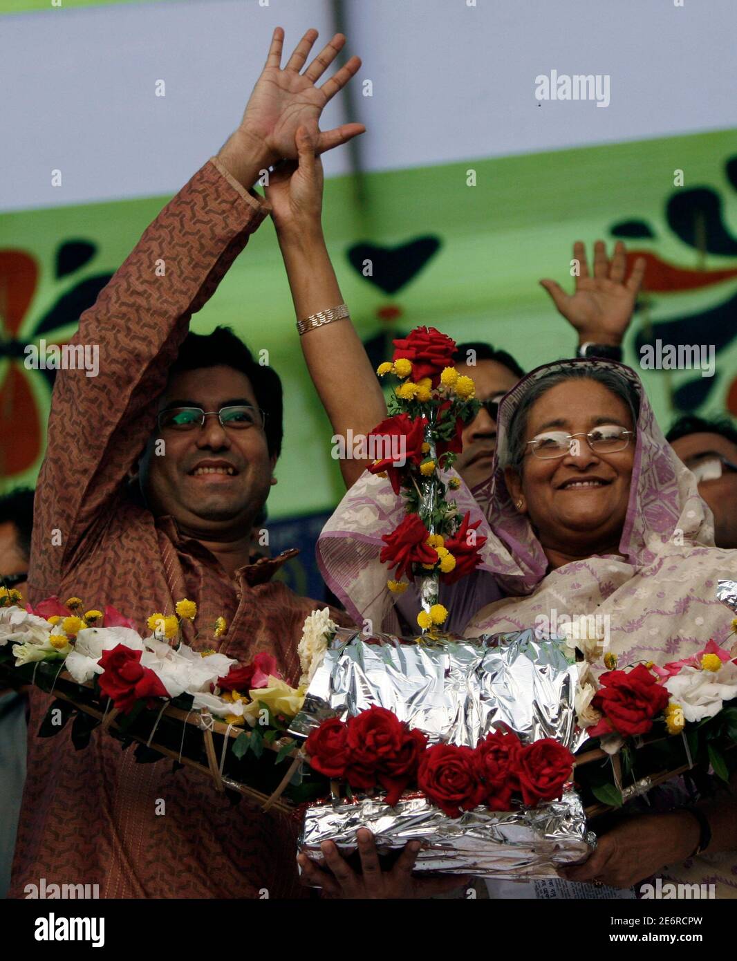 Bangladesh's Awami League president and former prime minister Sheikh Hasina introduces candidate Fazle Noor Taposh (L) during an election rally in Dhaka December 15, 2008. Hasina has started campaigning ahead of the December 29 parliamentary election. REUTERS/Andrew Biraj (BANGLADESH) Stock Photo