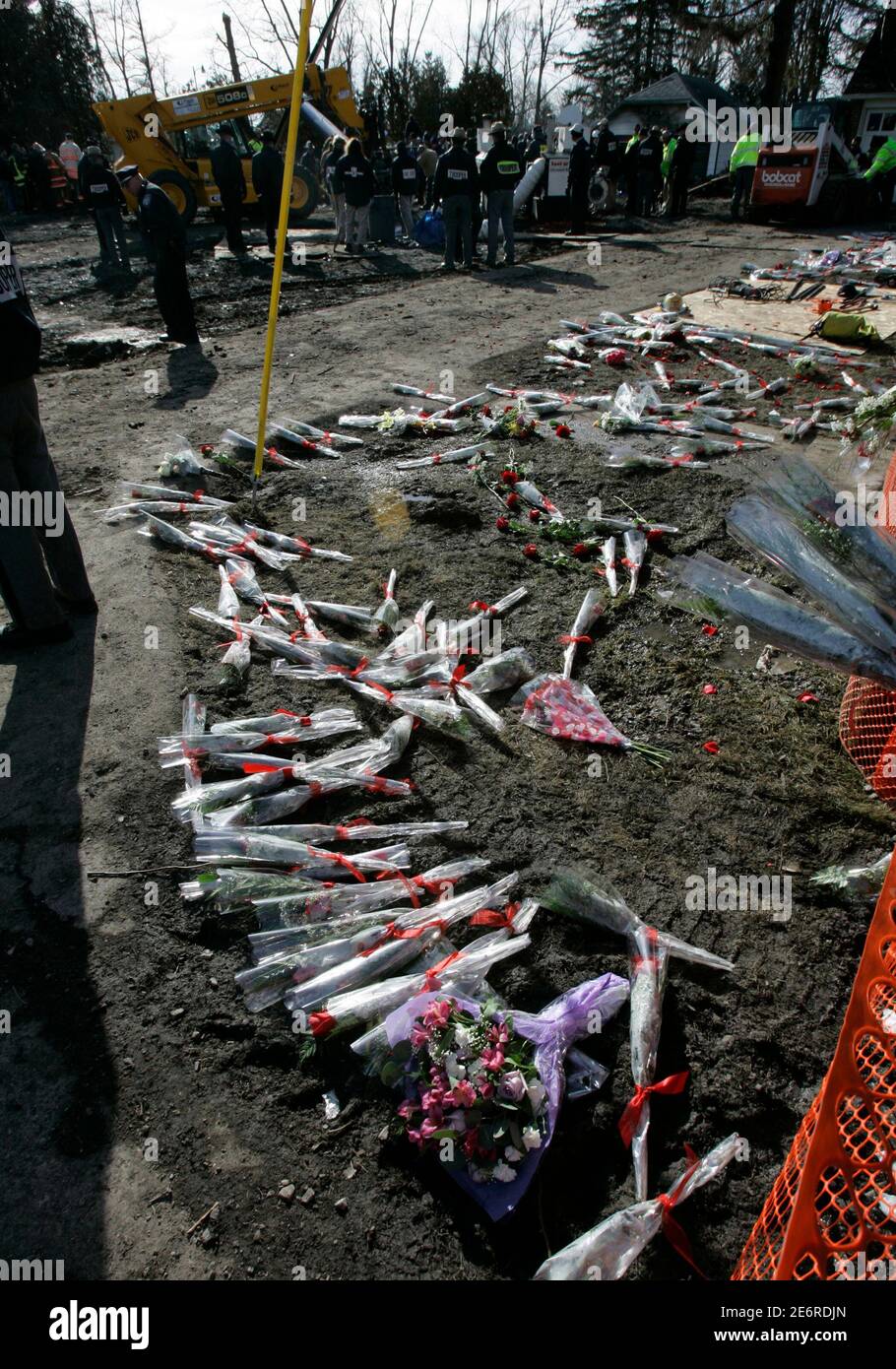 Family members of Continental Flight 3407 leave flowers at the crash